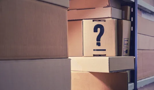 cardboard box with question mark painted on the side