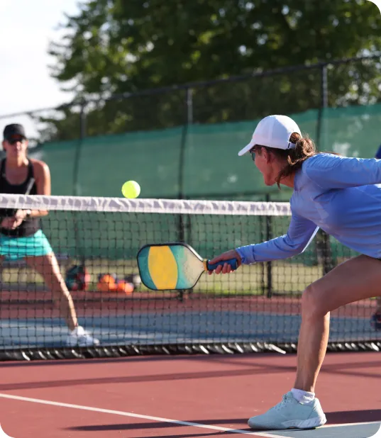 Group of people playing pickleball on an outdoor court