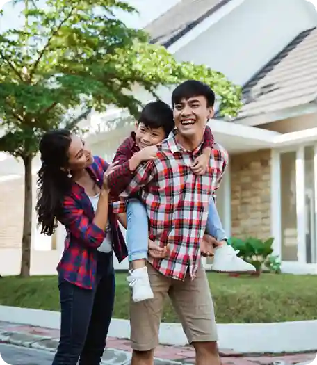 Happy family in front of their new home